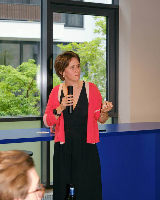 Margaux Pelen speaking with a microphone at One Last Prompt in Berlin
