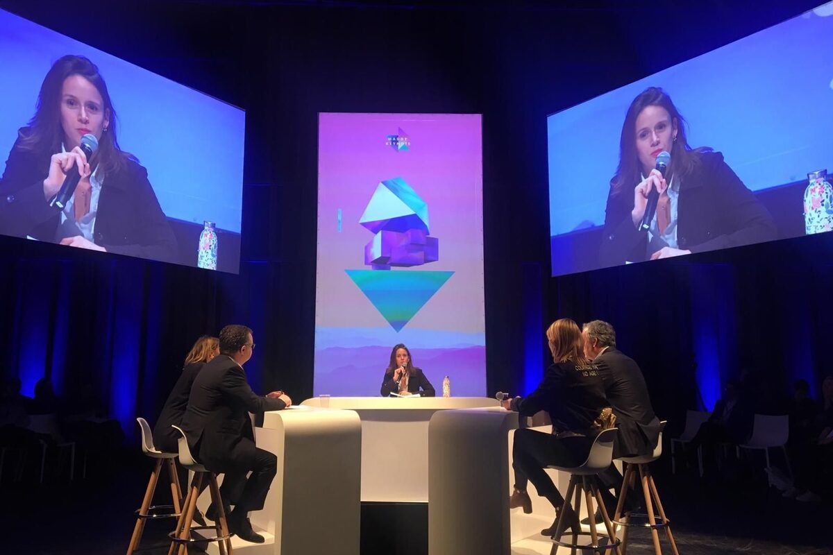 Margaux Pelen animant une table de quatre à MaddyKeynote, projetée sur les écrans de chaque côté de la scène