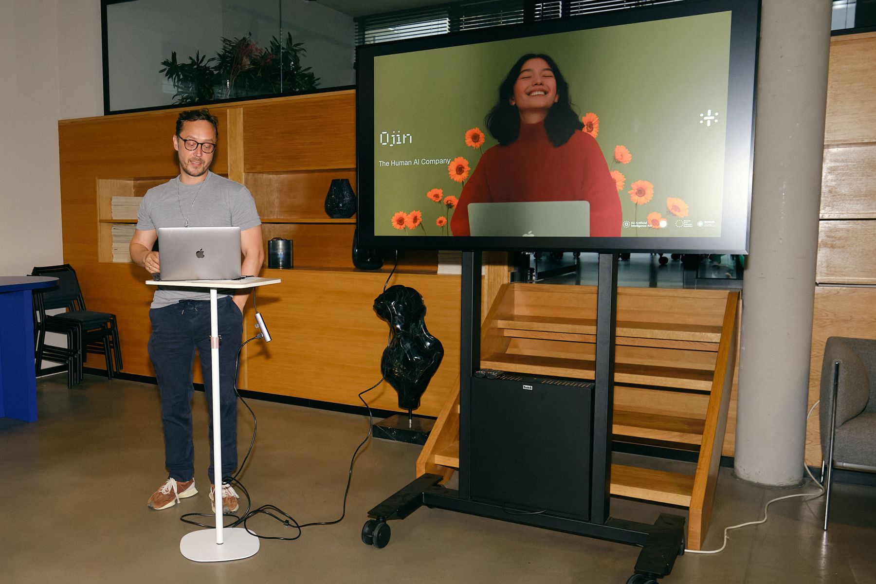 A builder demoing live from a laptop, the demo on the big screen behind