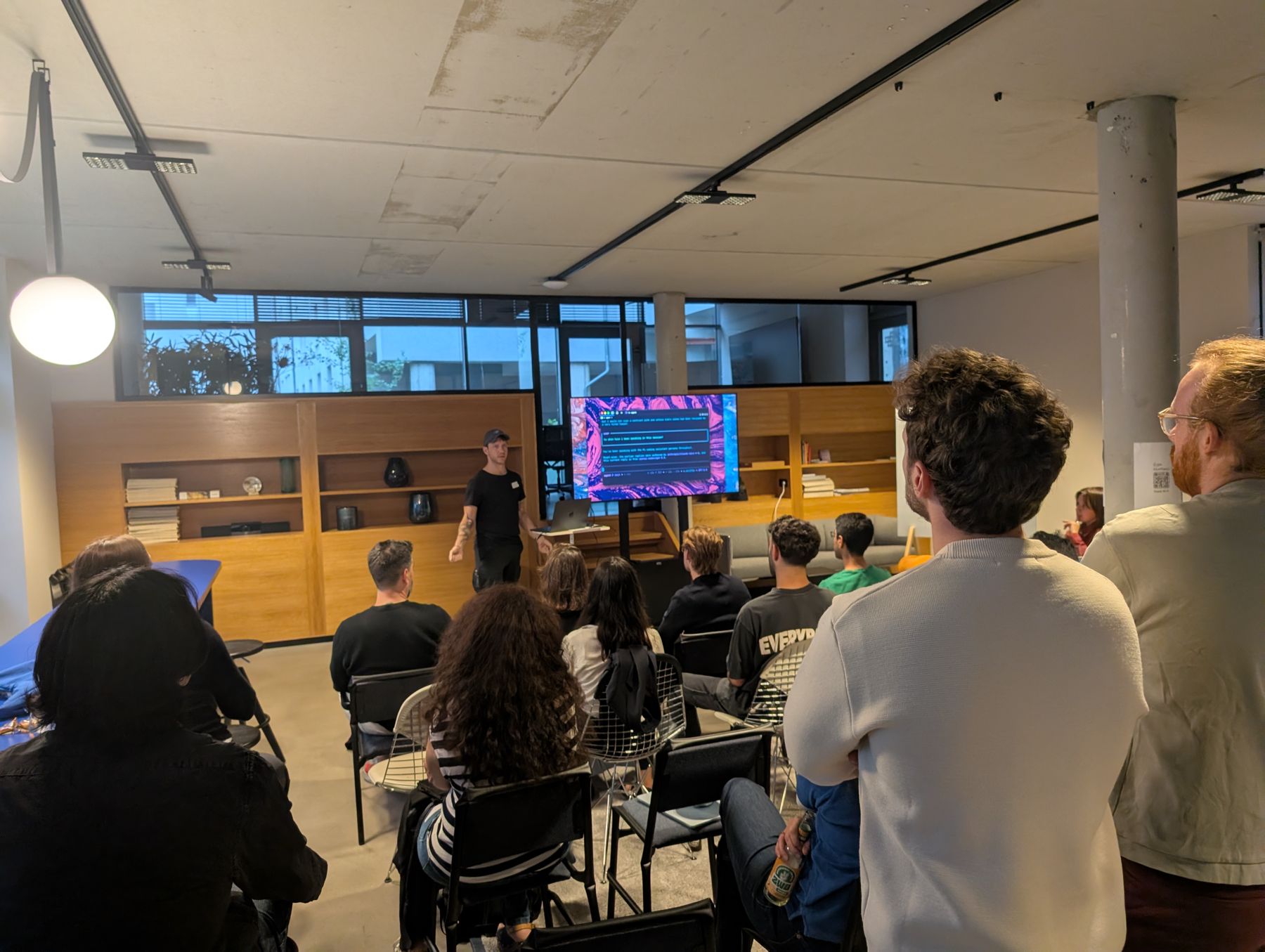 Guests watching a demo on the big screen