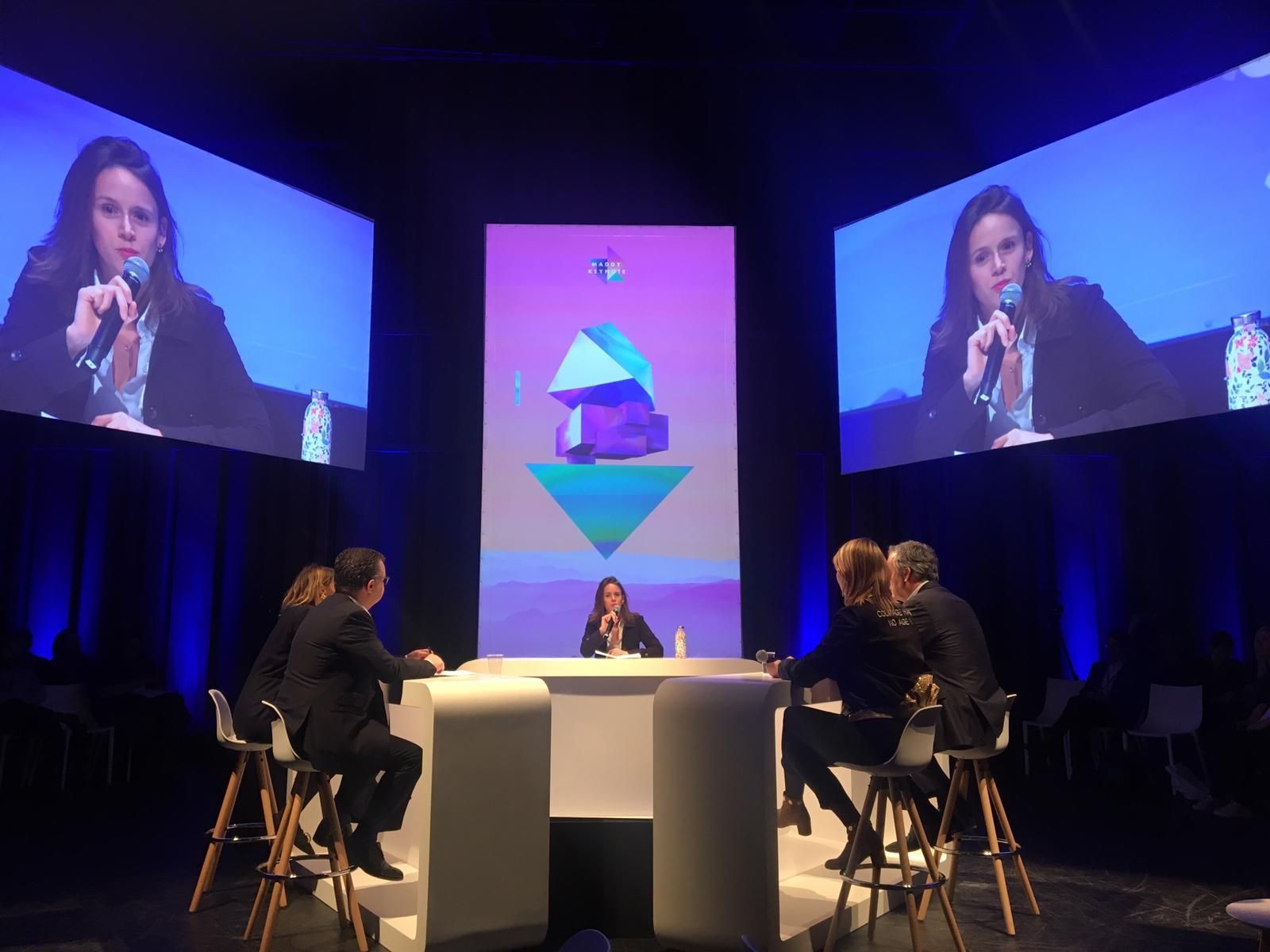 Professional panel discussion with blue stage lighting